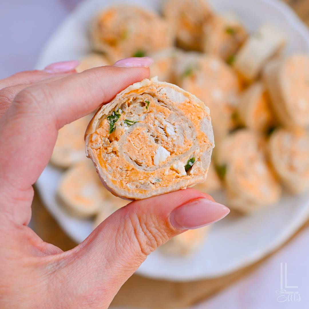 holding a buffalo chicken pinwheel.