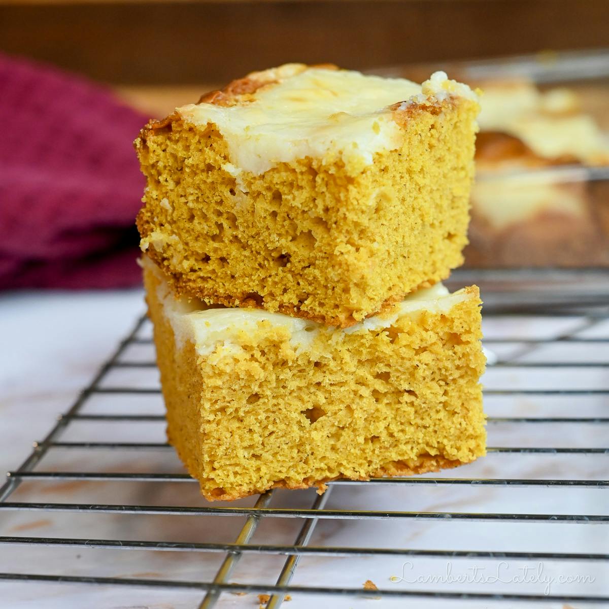 two pumpkin bars stacked on a baking rack.