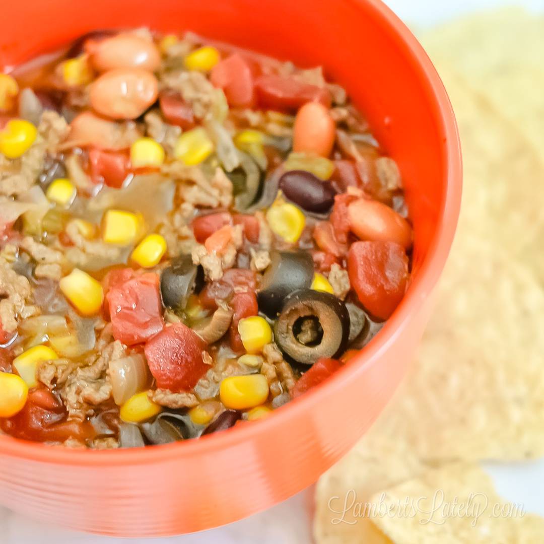 bowl of taco soup, surrounded by tortilla chips.