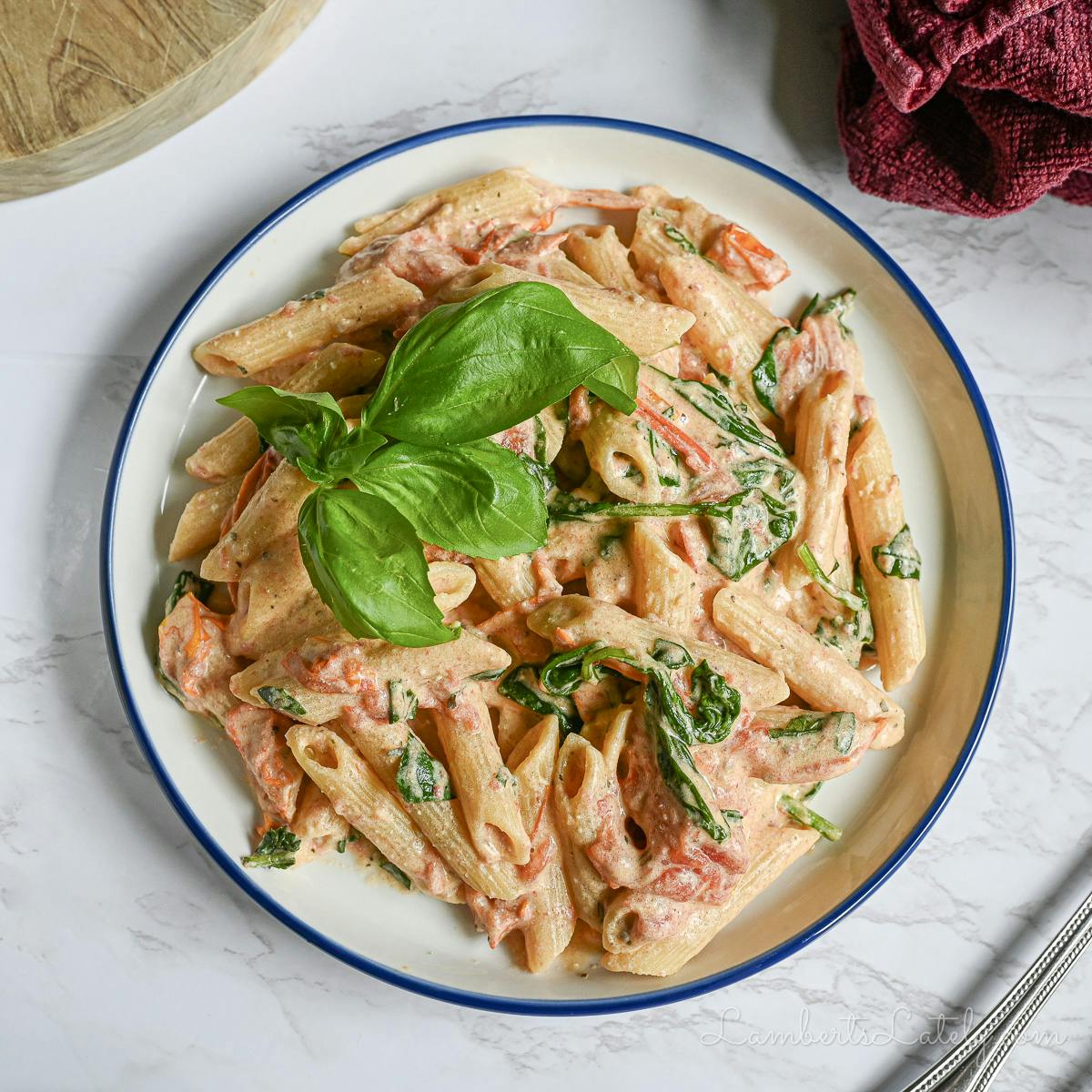 boursin cheese pasta on a plate, garnished with basil.