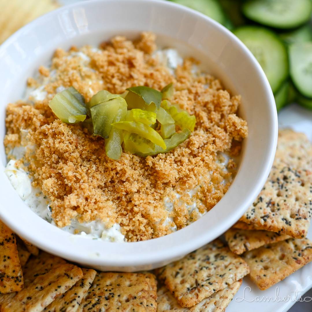 fried pickle dip, surrounded by crackers and cucumbers.
