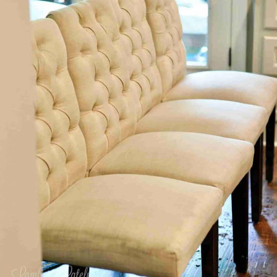 upholstered chairs in a line, being cleaned.