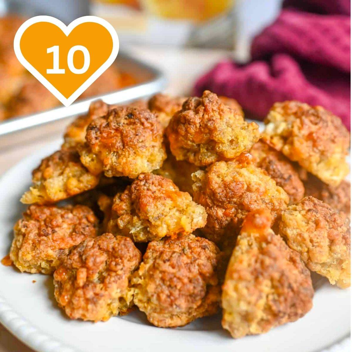 Golden-brown sausage balls made with Cheddar Bay biscuit mix, served on a white plate.