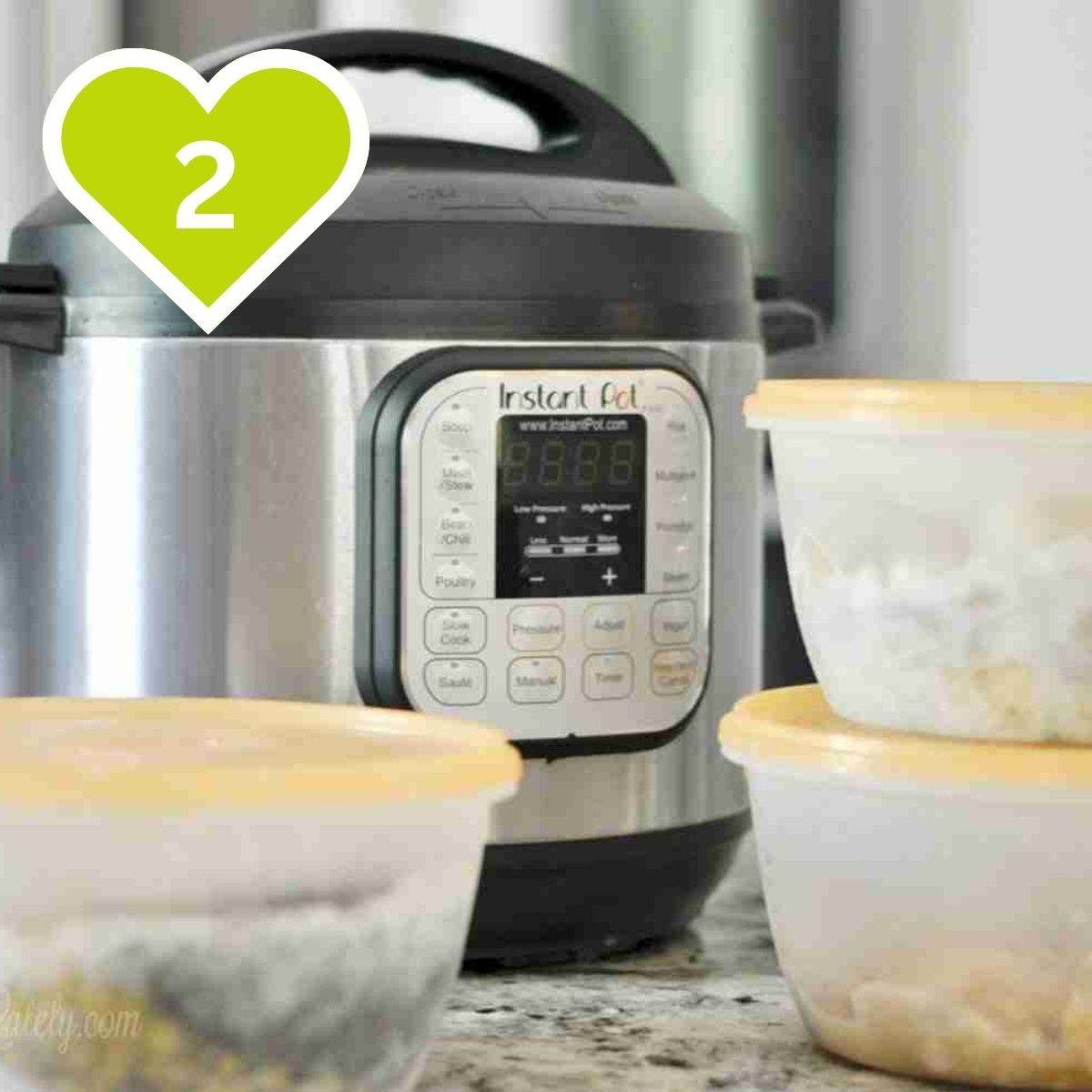 Instant Pot pressure cooker sitting on a kitchen counter next to prepped meal containers.