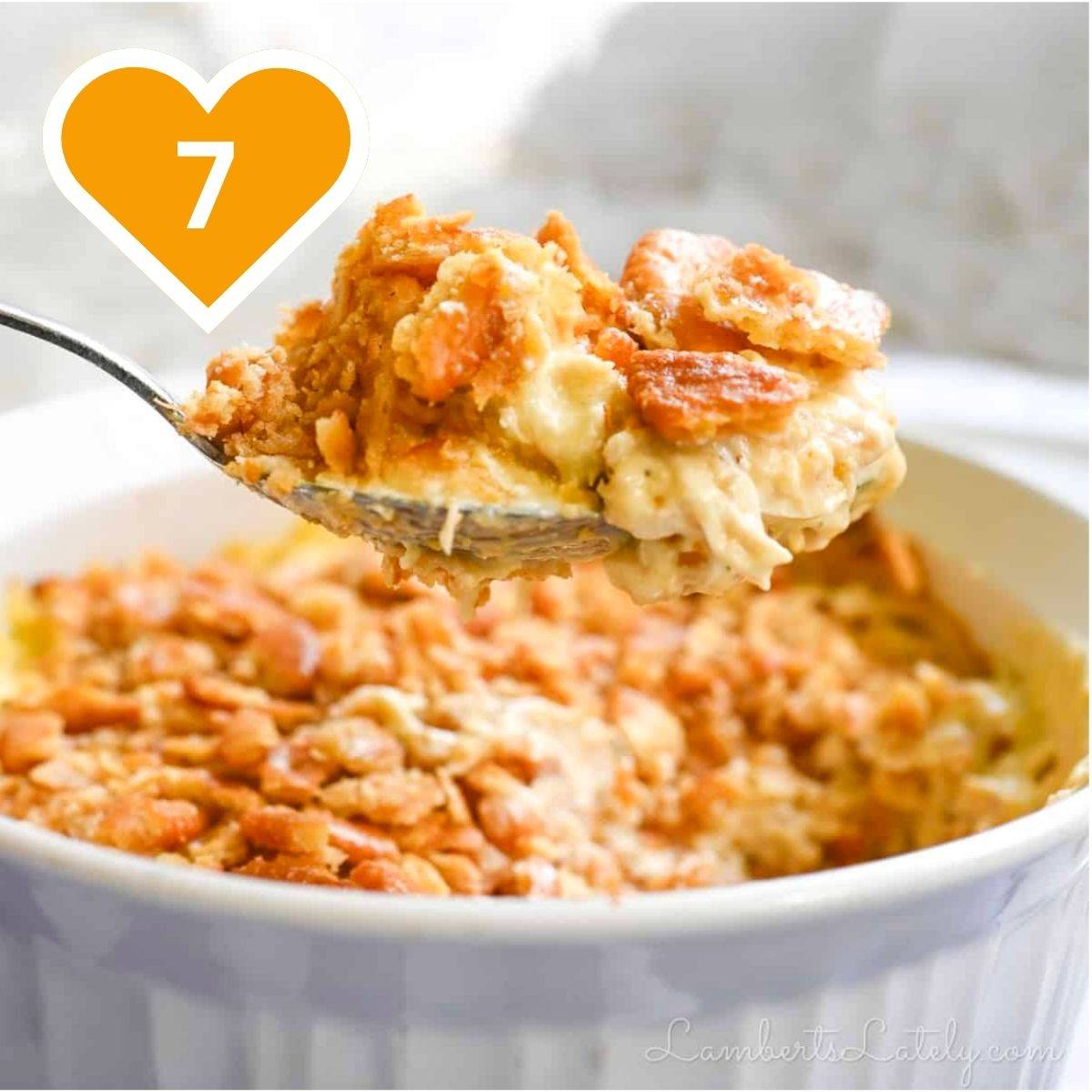 Creamy chicken casserole topped with crushed Ritz crackers, served in a white baking dish.