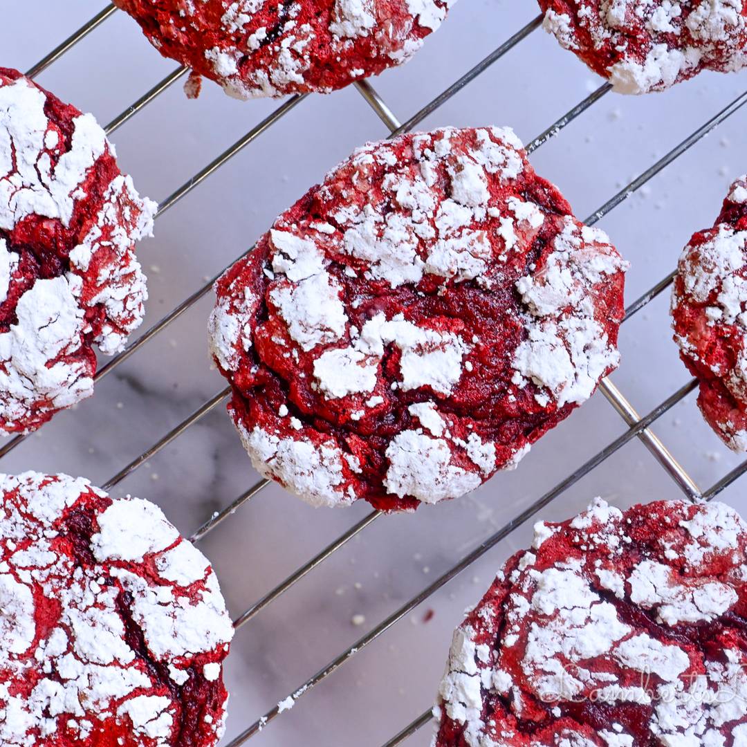 red and white red velvet cookies on a baking rack.