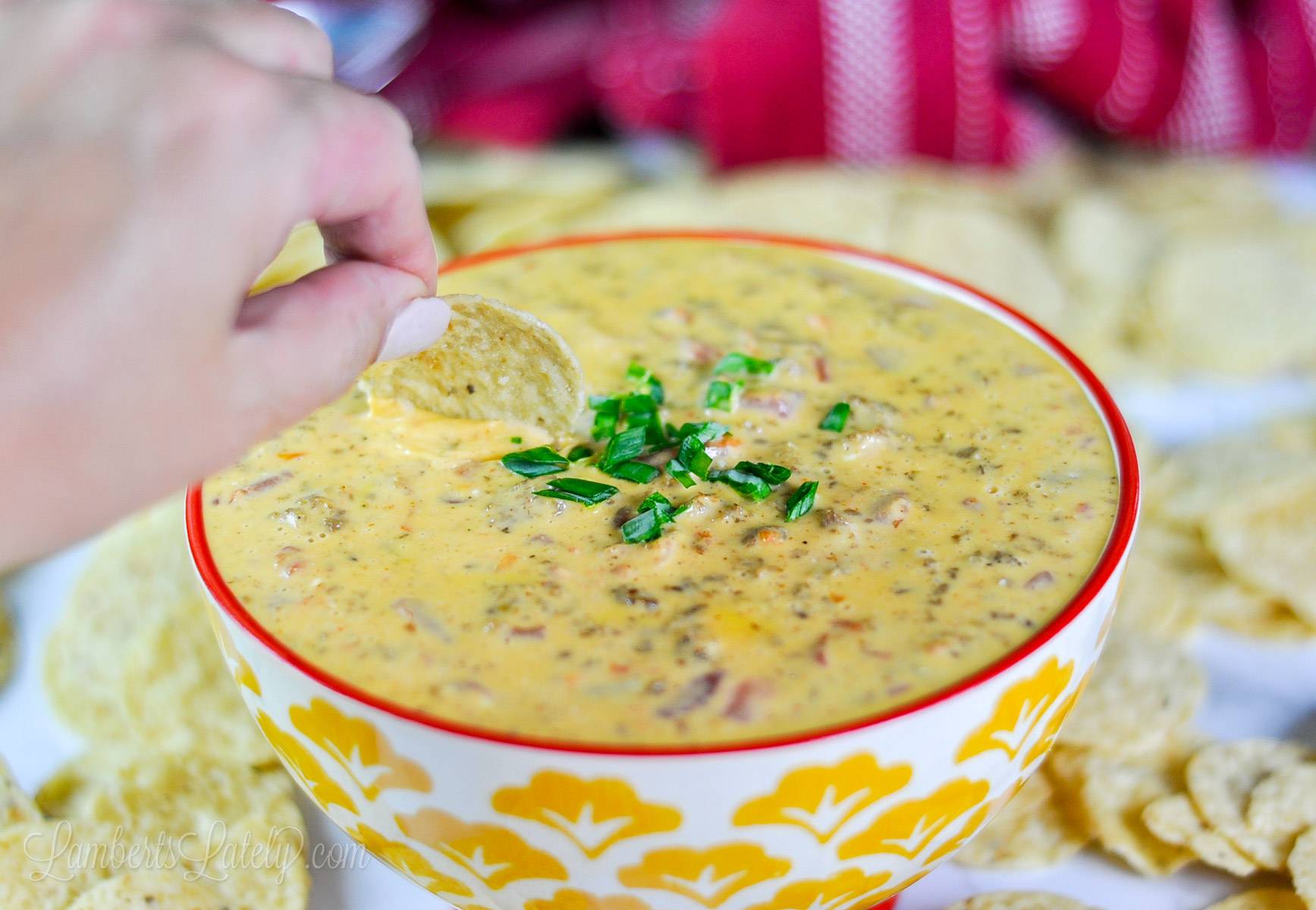 dipping a chip into rotel dip.