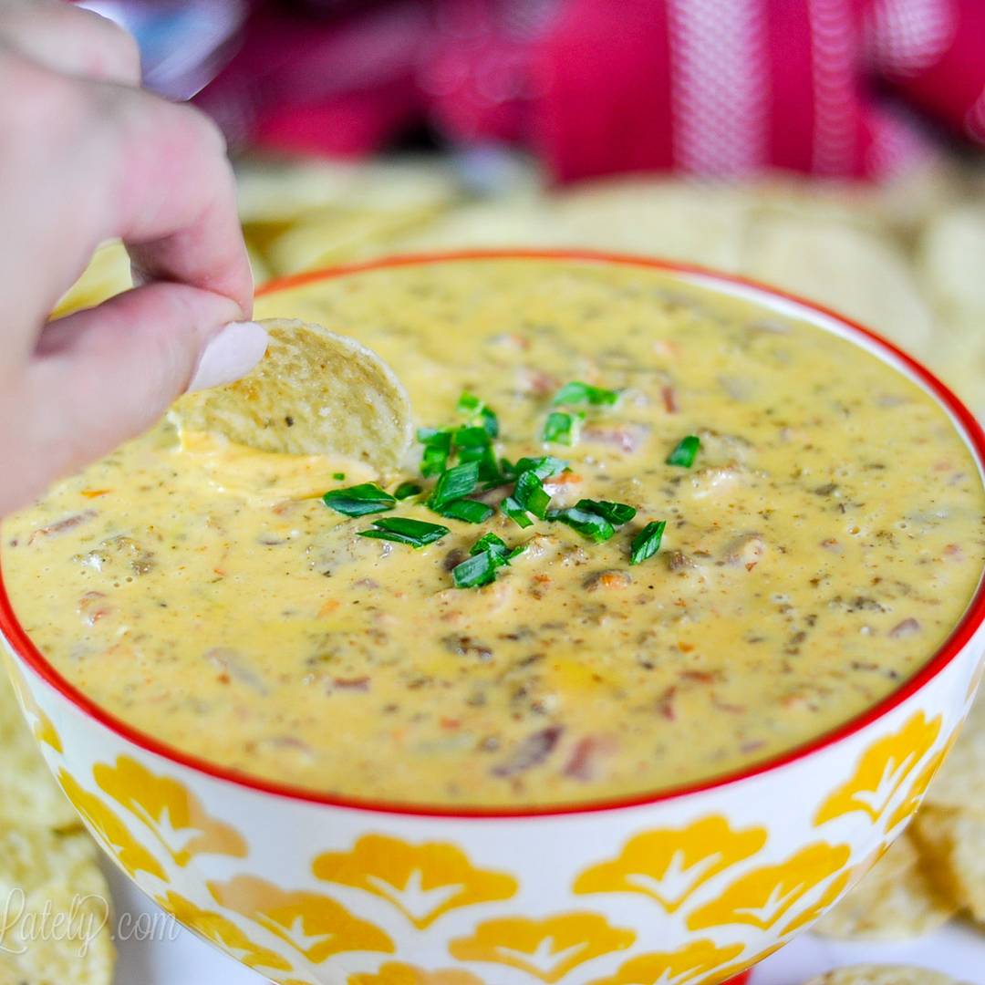scooping rotel dip out of a bowl.