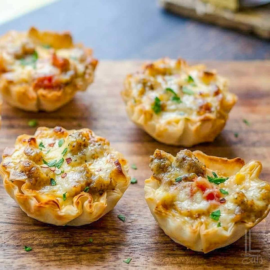 Sausage Rotel cups baked in crispy phyllo shells with sausage, cheese, and diced tomatoes.