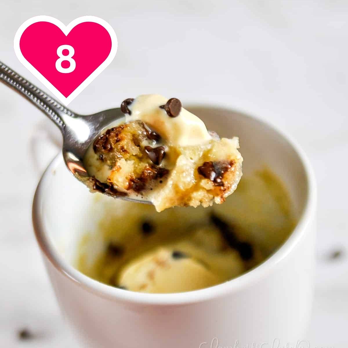 #8 - chocolate chip mug cake in a spoon, above a mug.