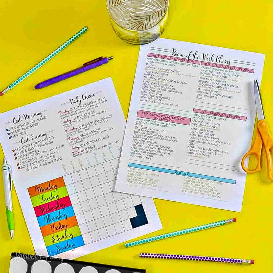 home cleaning schedule printables surrounded by office supplies.