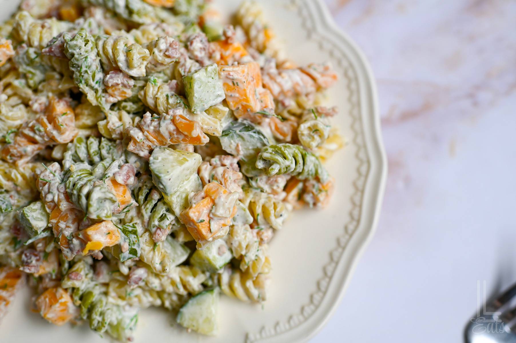 pickle pasta salad in a creamy sauce, on a plate.