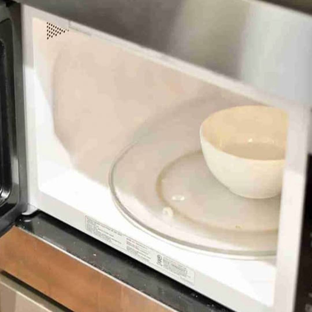 open microwave with a bowl.