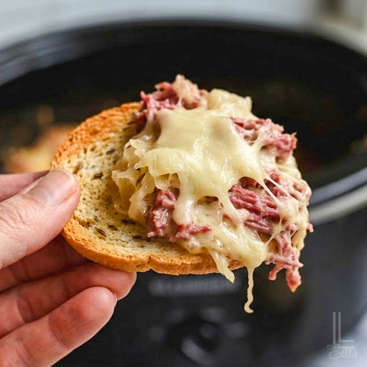 reuben dip on a bagel chip.