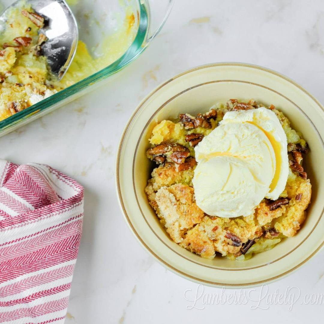 pineapple dump cake in a bowl, topped with ice cream.
