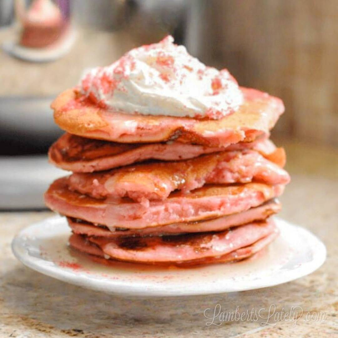 stack of cake mix pancakes topped with whipped cream, sprinkles.
