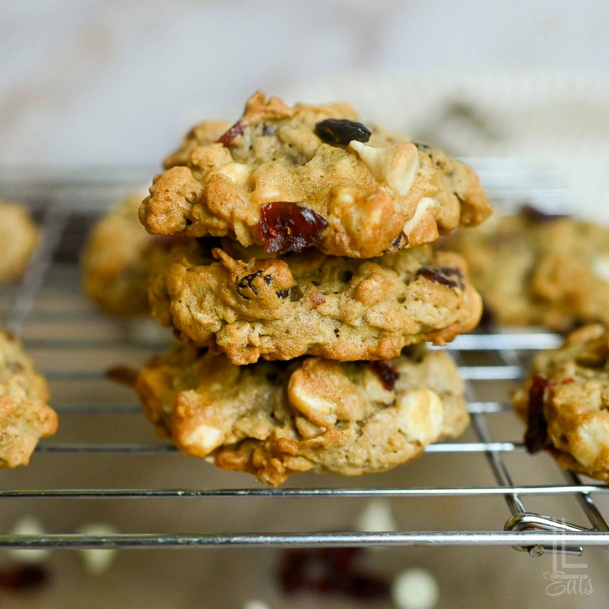 stack of cranberry oatmeal cookies on a baking rack.