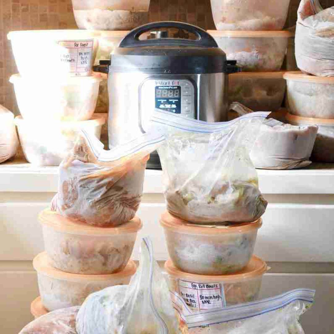 Stacks of prepped freezer meals in bags and containers ready for the Instant Pot.