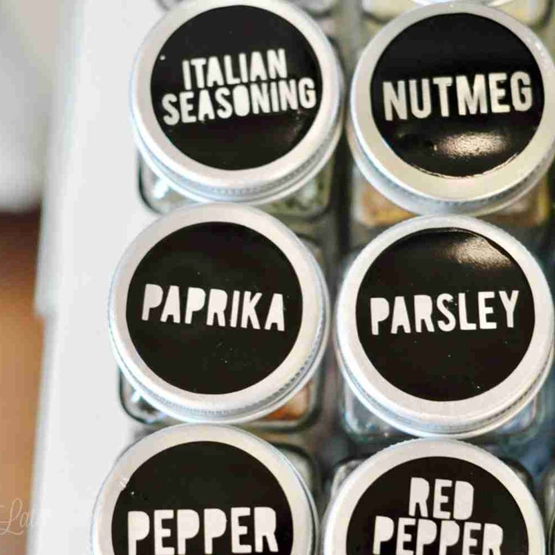 labeled spice jars in a cabinet.