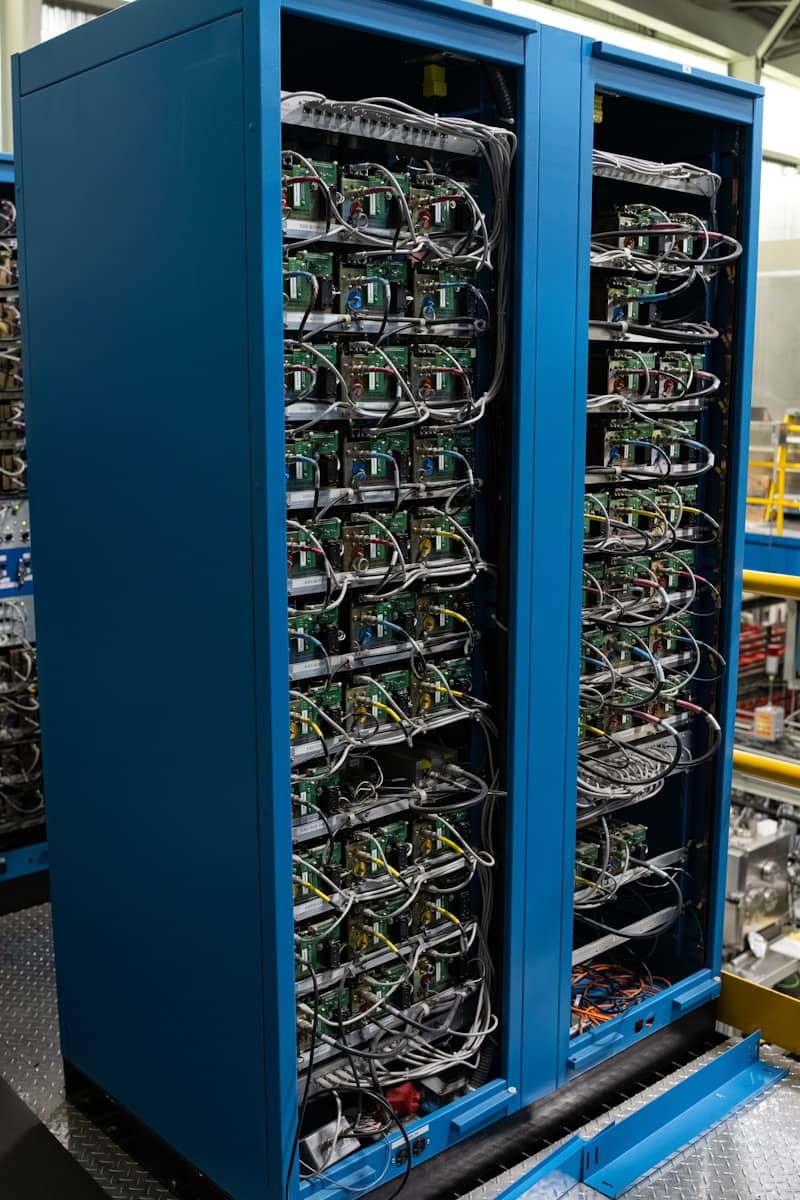 Two blue cabinets filled with complex electronic components.