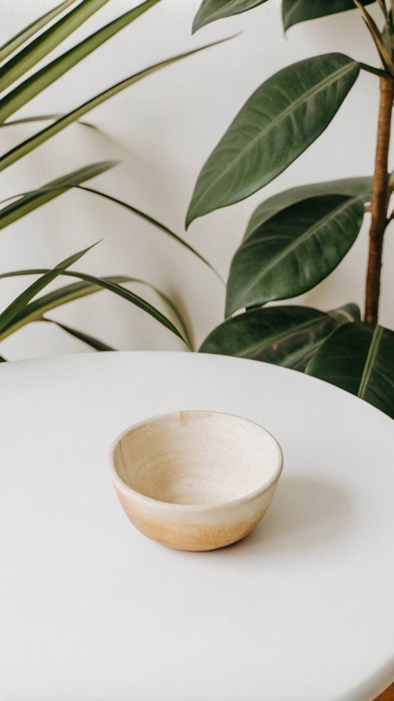 A white bowl sitting on top of a white table