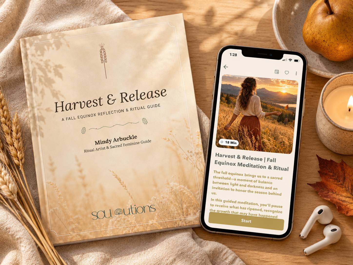 Fall equinox meditation and ritual guidebook beside a phone displaying the practice in the SOULutions App, surrounded by wheat, candlelight, a pear, and autumn leaves.