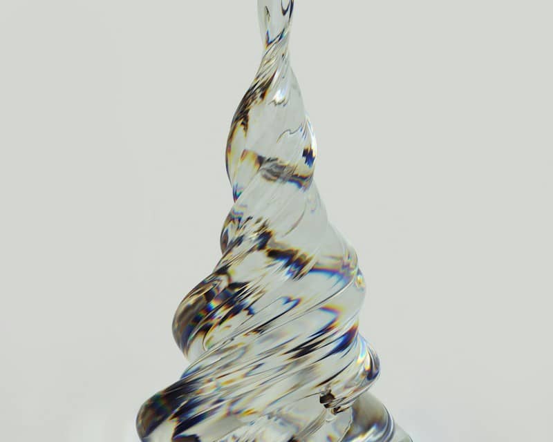 a glass sculpture of a tree on a table