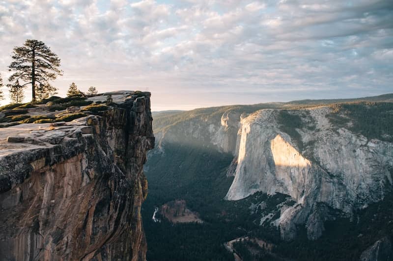 cliff overlooking mountain during daytime