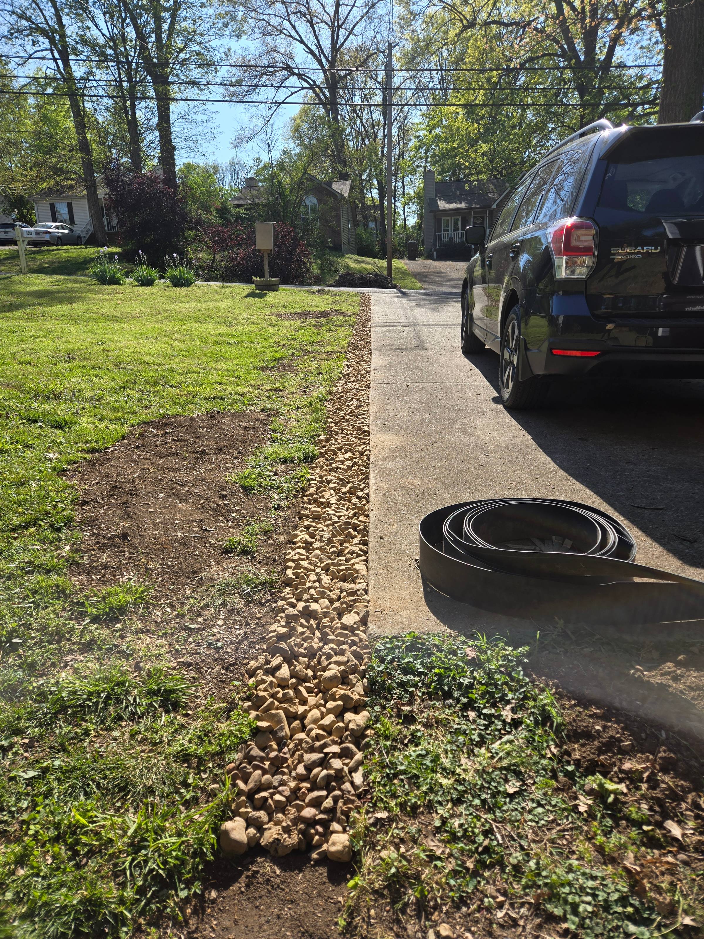 Amanda shows a dry river bed running along her driveway.