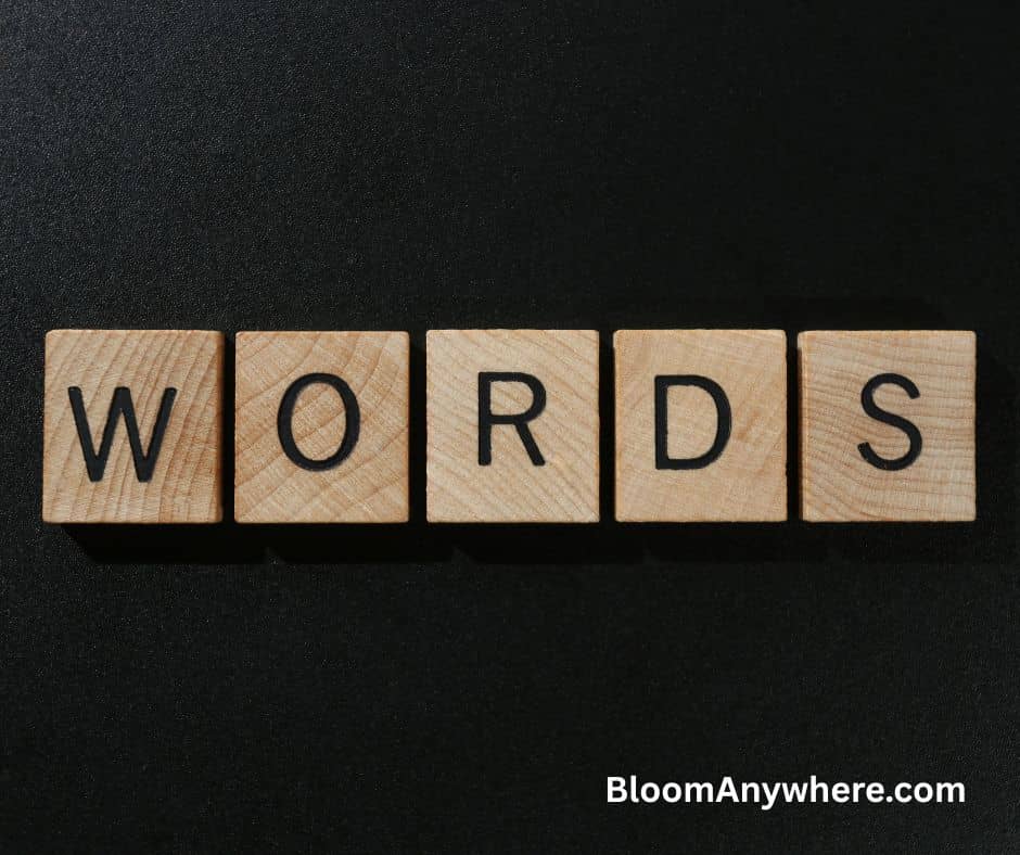 Brown Scrabble tiles that spell out the word "words" against a black background