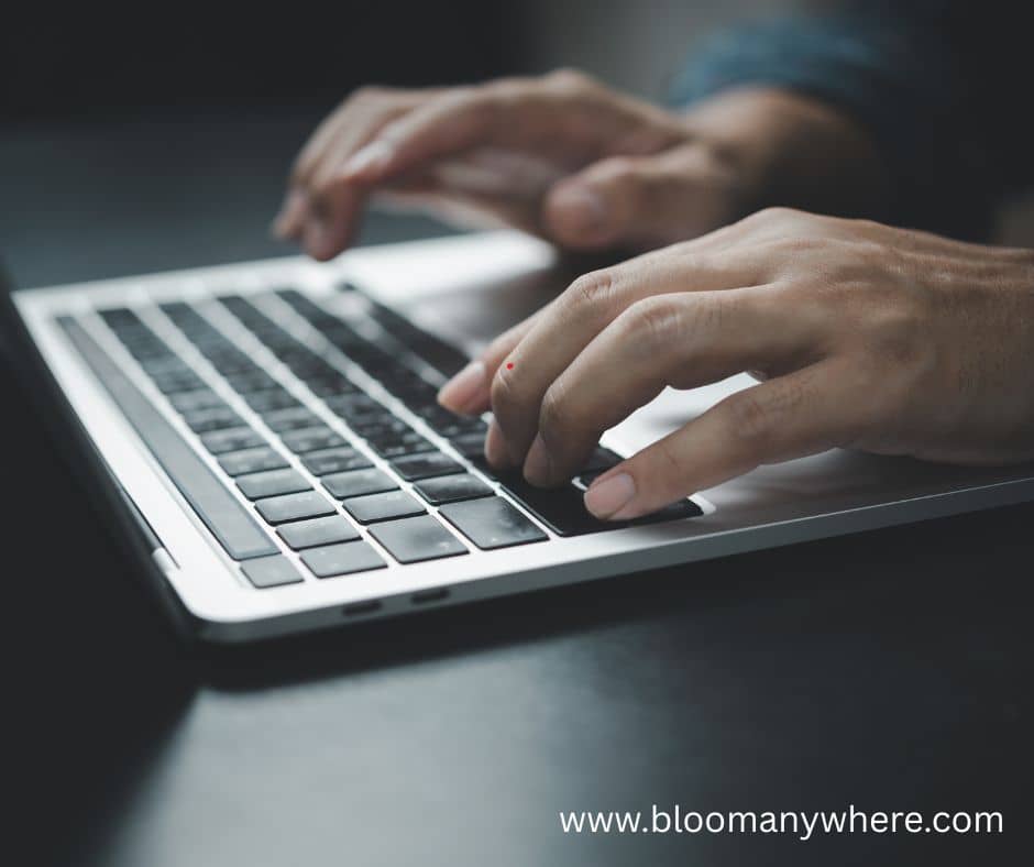 Two hands on a laptop keyboard