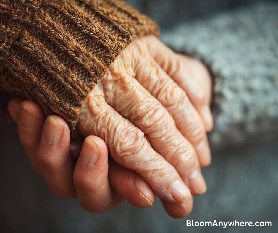 Two people, one older and one younger, holding hands