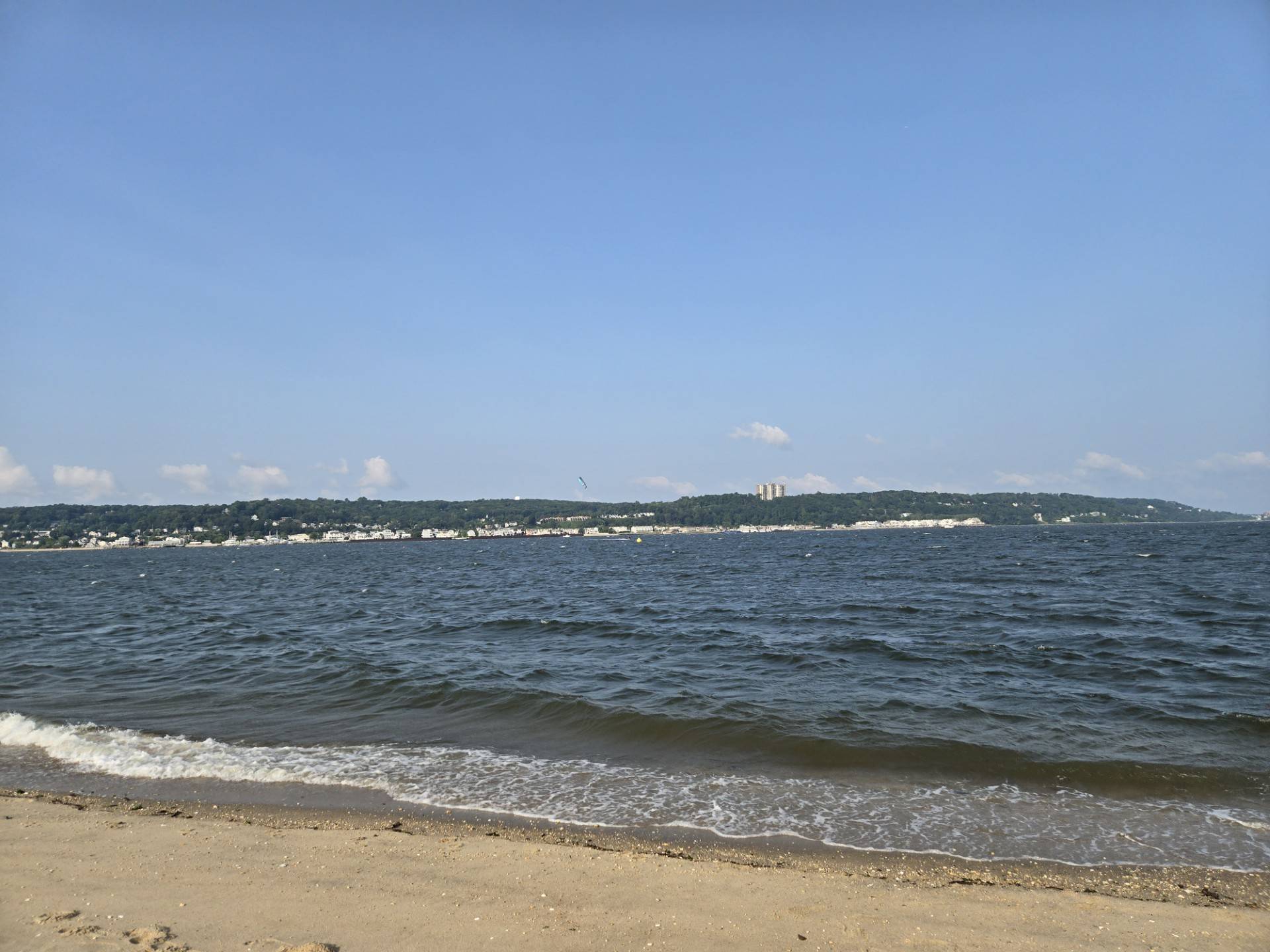A photo of Sandy Hook bay and beach with a blue sky overhead