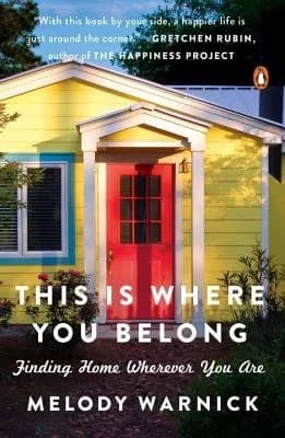 An image of the cover of This Is Where You Belong featuring a yellow house with a red door and blue window trim