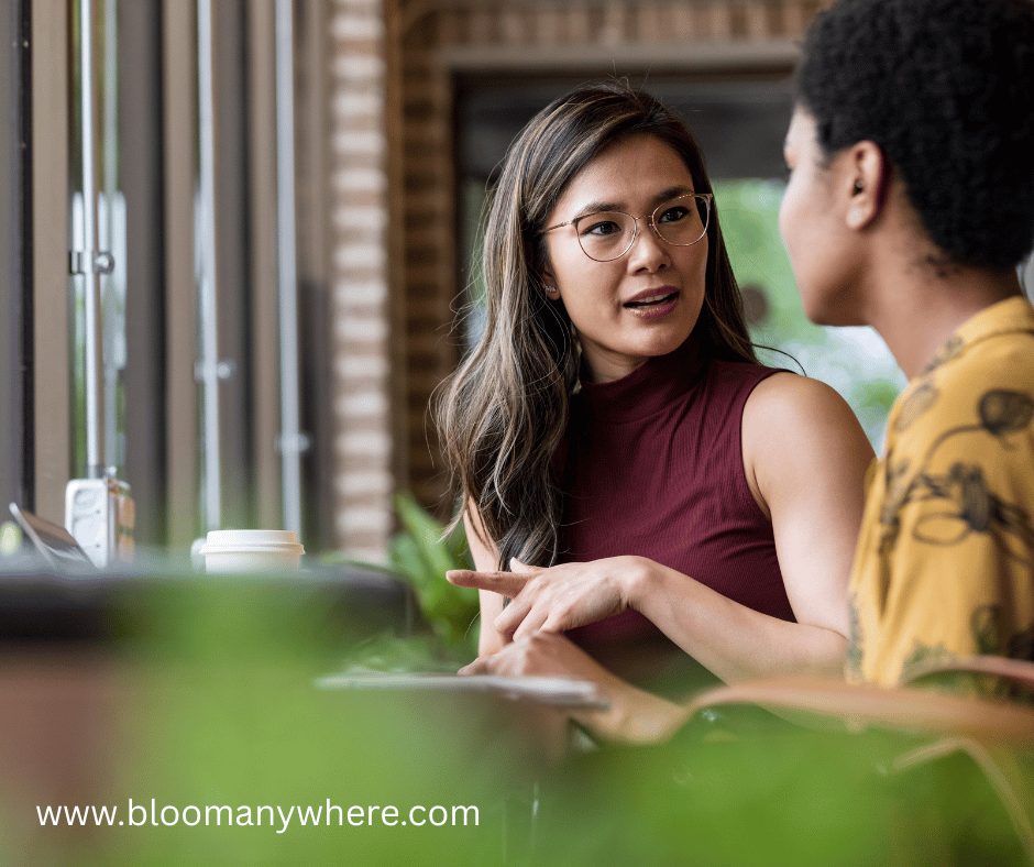Two women in a cafe engaged in serious discussion.