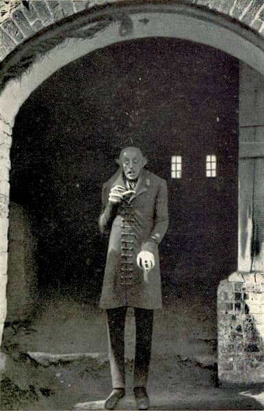 Nosferatu (1922) standing in a doorway