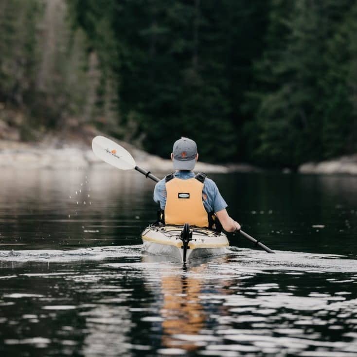 person sitting on kayak during daytime