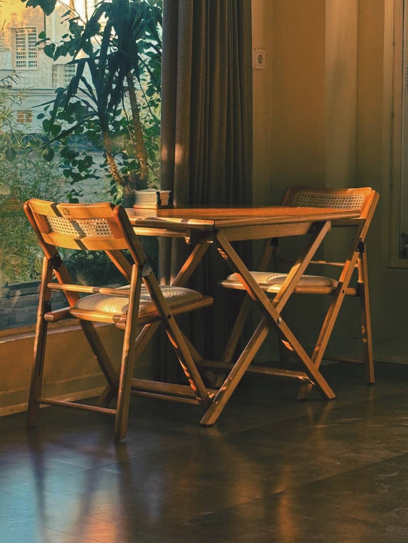 A table and two chairs in front of a window