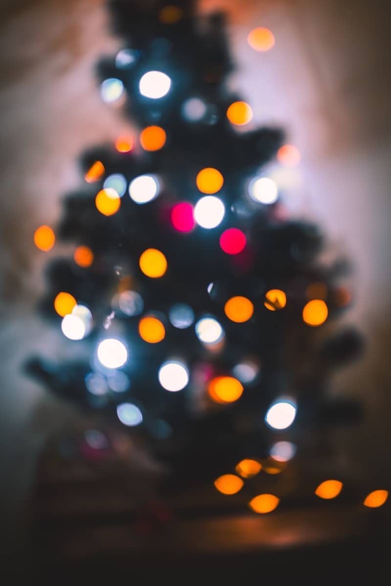 Blurred christmas tree lights glow in the dark.