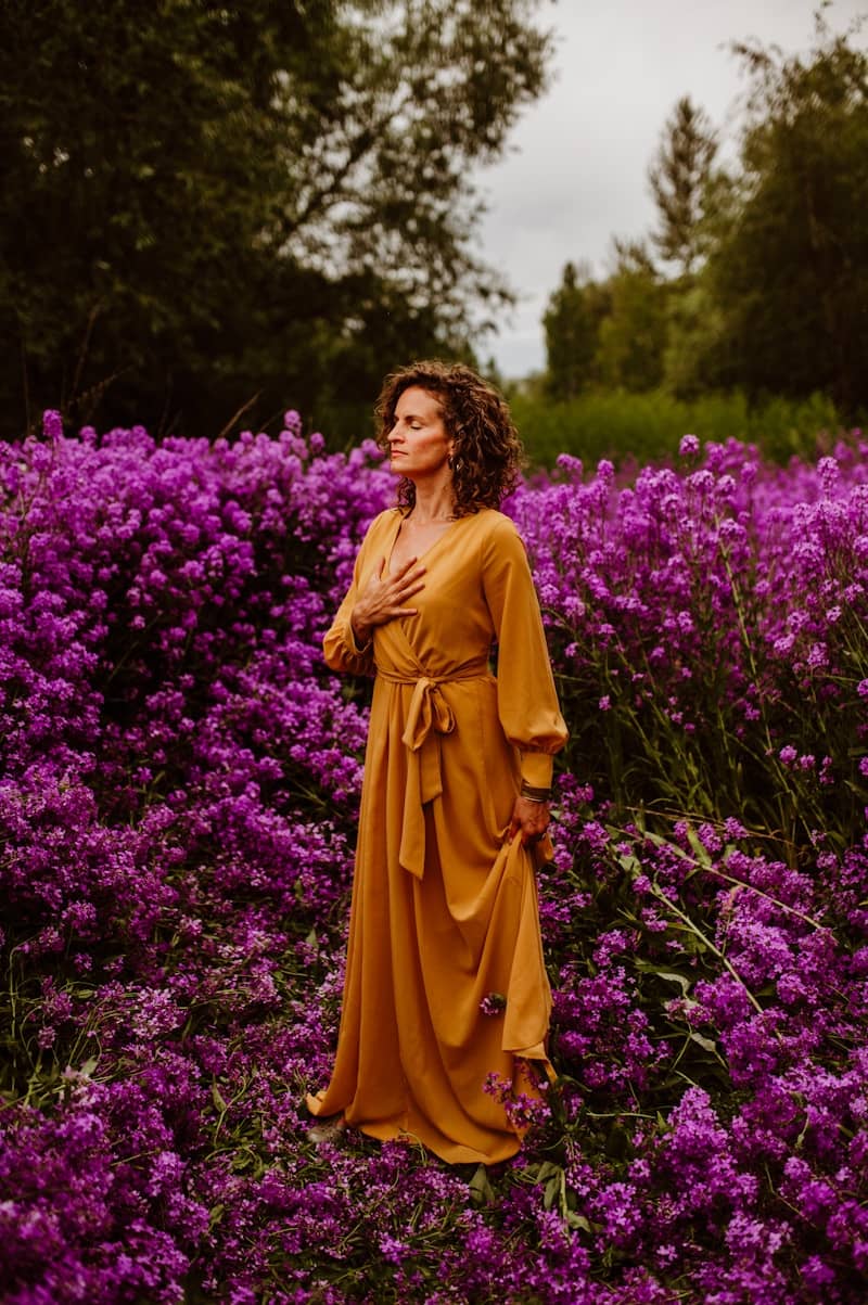 A woman standing in a field of purple flowers