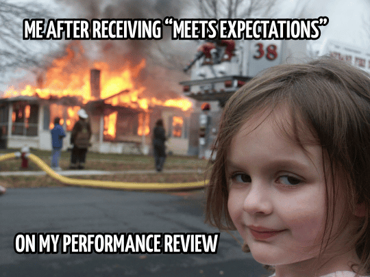 Disaster Girl meme with the caption "Me after receiving meets expectations on my performance review"
