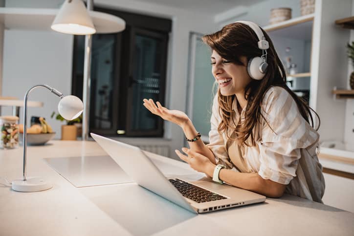 A woman working from home with headphones on