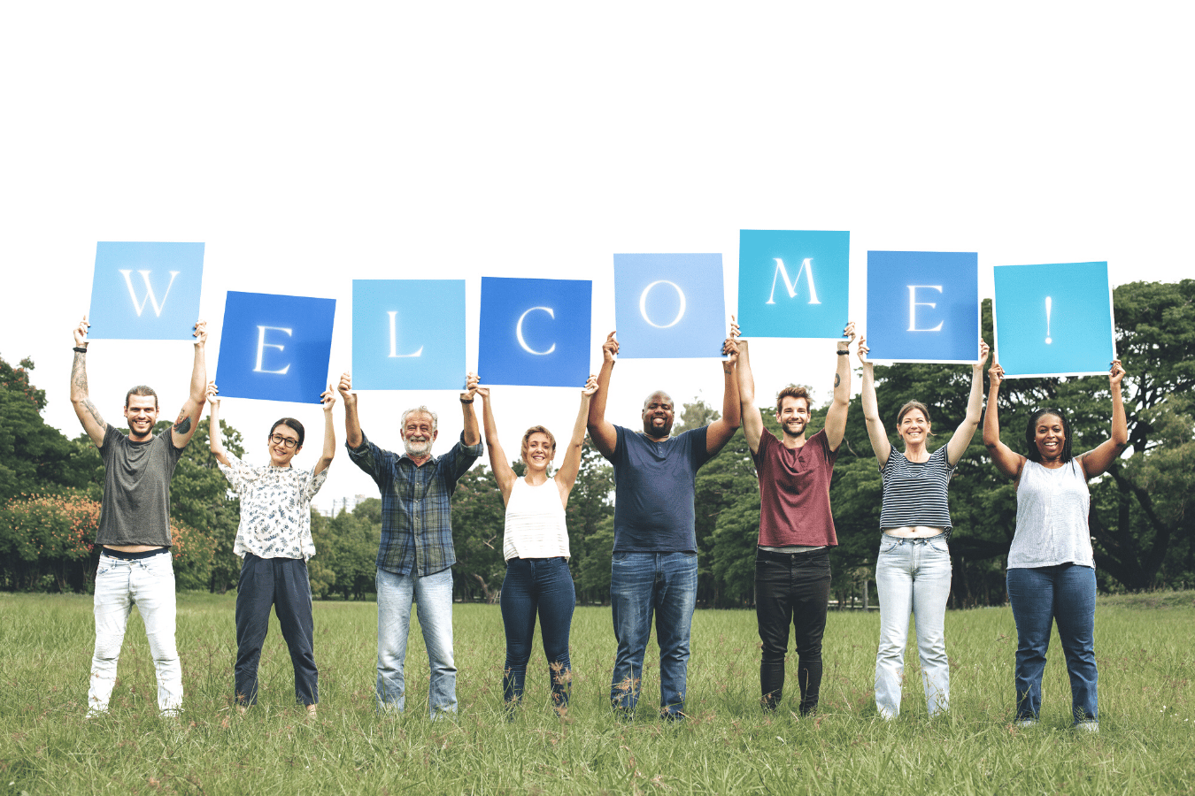 Group of people holding a "Welcome!" sign