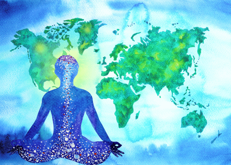 A person in lotus position in front of a world map