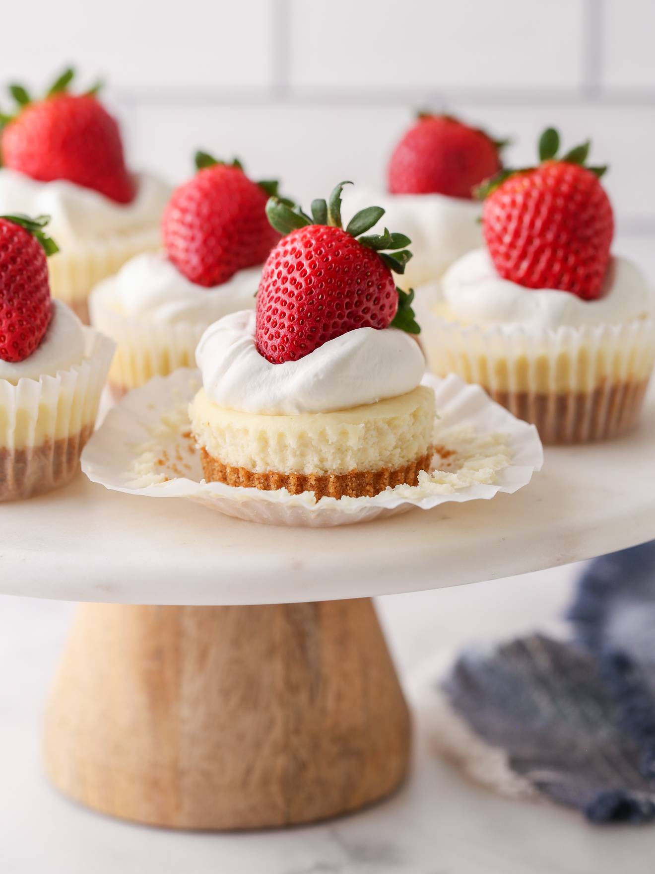 mini cheesecakes on a cake stand
