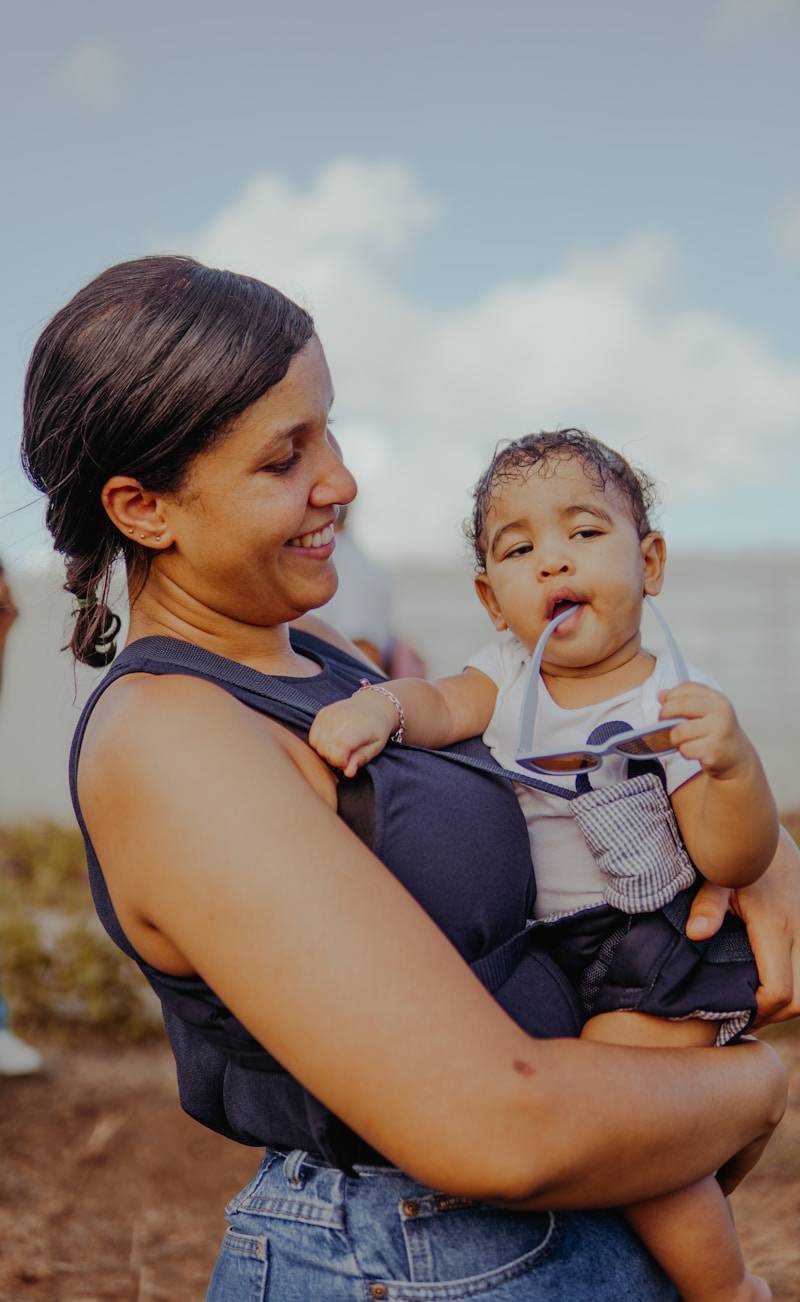 a woman holding a baby in her arms