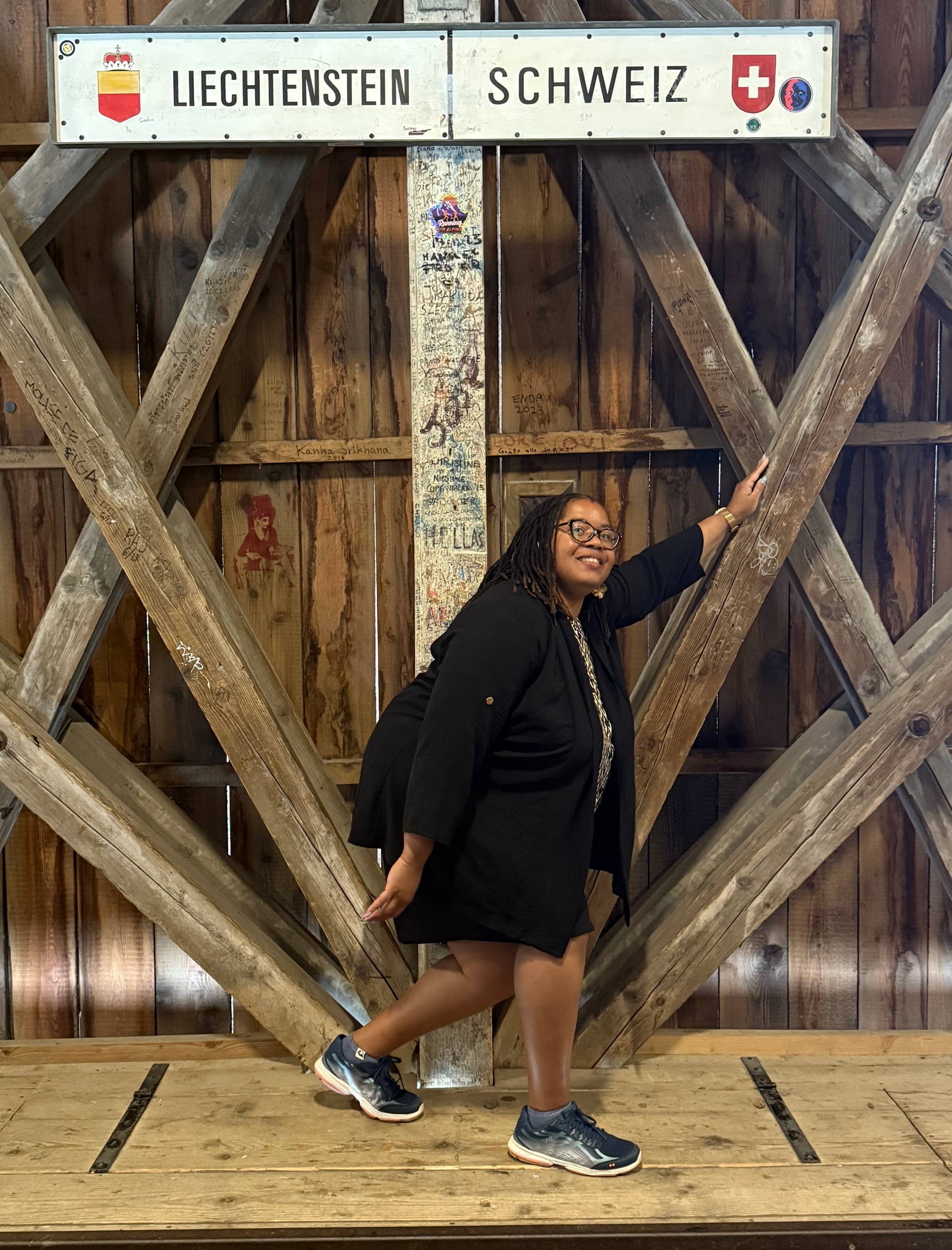 image of me on the bridge straddling both Switzerland and Liechtenstein