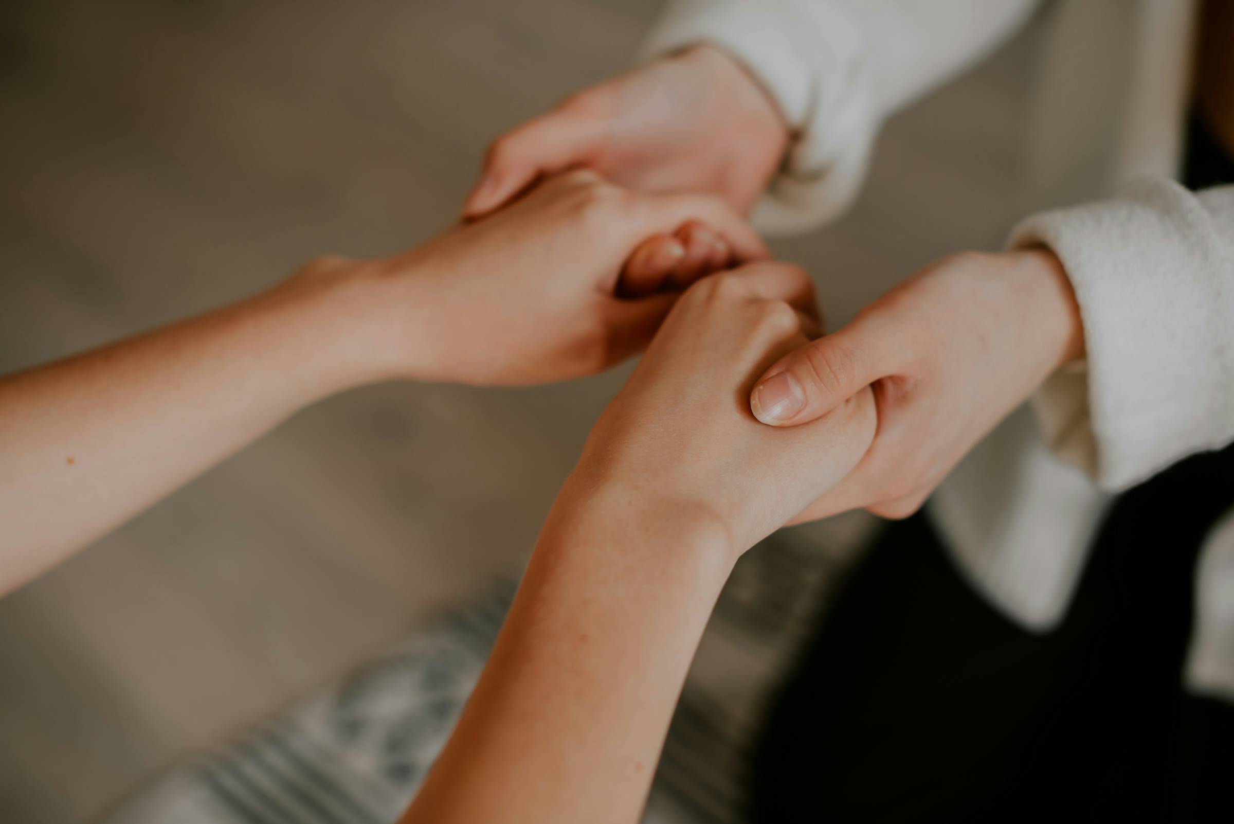 Hands holding in support.