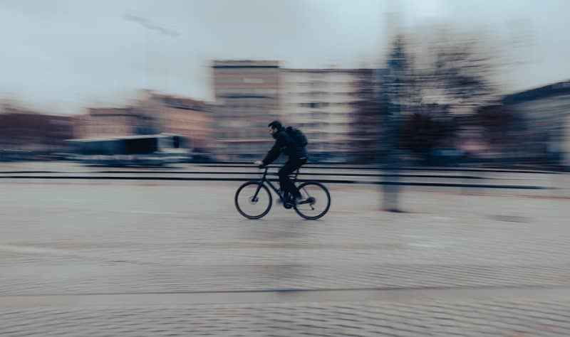 Person riding bicycle with motion blur effect
