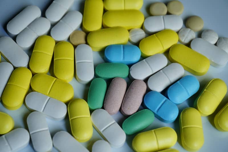 Various colorful pharmaceutical pills and capsules scattered